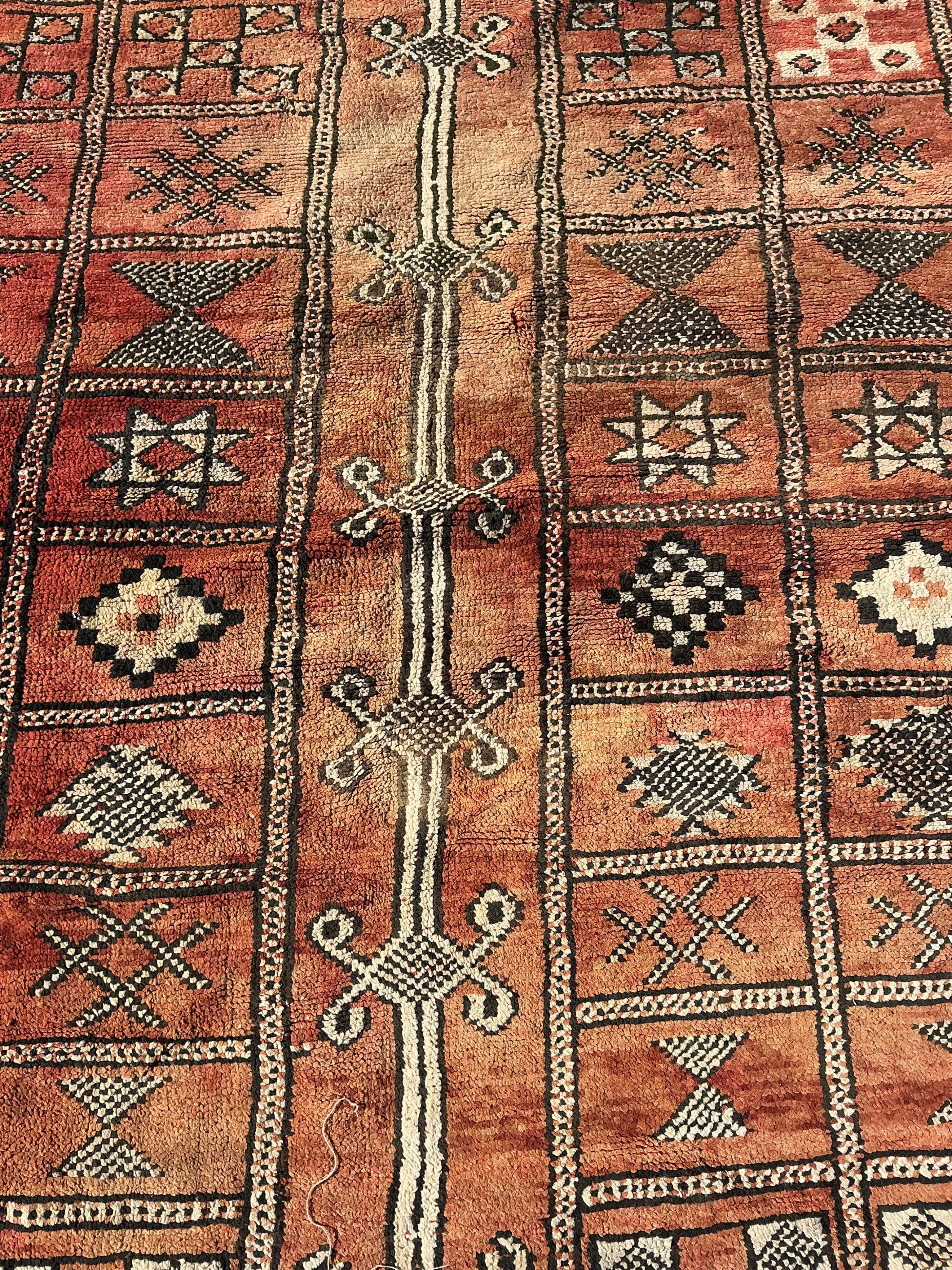 A Moroccan Berber pale red ground carpet, 300 x 190cm